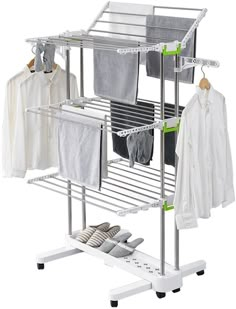 an ironing rack with clothes hanging on it