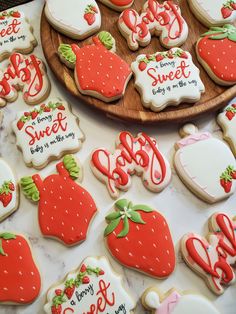 some decorated cookies are on a table and one is for someone's sweetest