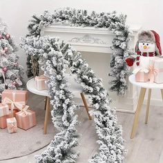 christmas decorations and presents in front of a fireplace