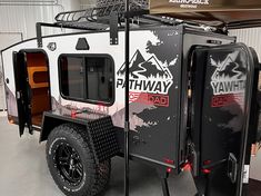 an off - road trailer is parked in a garage