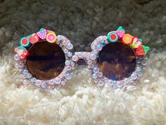 Fruity Sunglasses handmade for your fabulous & fun toddler/child!    * for kids ages 1 to over 5  * (check the size below before ordering if you are unsure.)   * Sunglasses bag provided for protection.  Perfect for outdoor activities, photoshoots, birthday parties, party favors, classroom gifts, beach, traveling, etc.!  If you have any other custom ideas, or clarifications, feel free to message me directly! I am open to custom designs.  *Please note that if you request a different customization, I am likely able to do it, but it may take longer if I do not have the supplies available at the time of request. I will guarantee that I will do my best to oblige to custom orders within reasonable requests. *  No refunds or returns.  If there is an issue upon arrival of product - please contact m Fun Handmade Sunglasses For Summer, Fun Handmade Sunglasses As A Gift, Novelty Adjustable Sunglasses For Beach, Fun Handmade Pink Sunglasses, Handmade Fun Summer Sunglasses, Handmade Fun Pink Sunglasses, Fun Pink Handmade Sunglasses, Cute Glass Sunglasses For Summer, Summer Gift Sunglasses With Glass Material