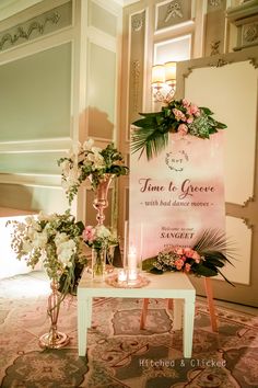 a table with flowers and candles in front of a sign that says time to choose