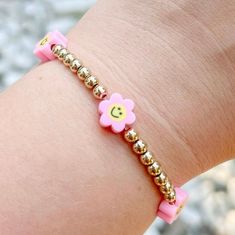 Trendy smiley face flower bracelets with gold details. Pair with any outfit by choosing more than one color flowers. Perfect for any occasion! Trendy Flower Bracelets For Friendship, Casual Gold Friendship Bracelets For Spring, Playful Pink Flower Bracelets, Trendy Summer Bracelets With Flower Charm, Trendy Pink Flower Friendship Bracelets, Trendy Flower Shaped Friendship Bracelets Gift, Trendy Summer Bracelet With Flower Charm, Cute Flower Bracelets For Friendship, Trendy Flower Friendship Bracelets Gift