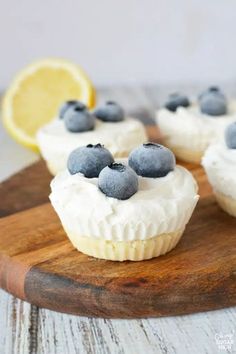 lemon and blueberry cupcakes on a wooden cutting board