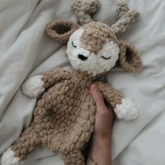 a person is laying in bed with a stuffed animal that looks like a bunny rabbit