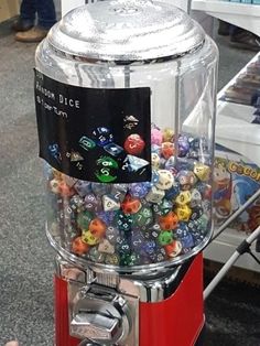 a gummy machine with lots of different colored dices in it's display case