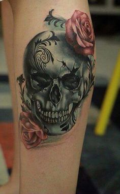 a woman's leg with a skull and roses on it