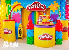 the play doh stand is decorated with balloons and candy buckets for birthday parties