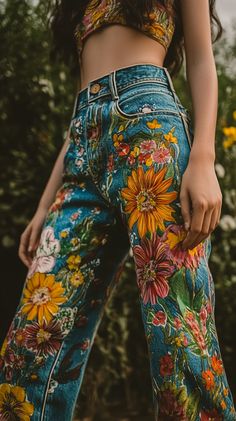 Colorful hand-painted jeans adorned with floral patterns, showcased on a model in natural light, shot using a Canon EOS R5 and RF 50mm f/1.2L lens with rich details. Floral Pant Outfit, Painted Mom Jeans, Painted Jeans Mushroom, Jeans Design Ideas Diy, Floral Painted Jeans, Fabric Painted Jeans, Jeans Decoration Ideas, Art Jeans Paintings