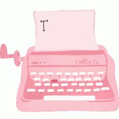 a pink typewriter with the letter t on it