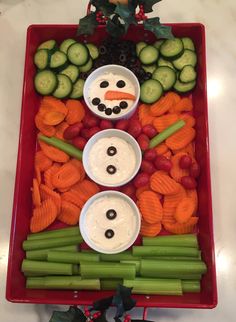 a tray with carrots, cucumbers, celery and other vegetables