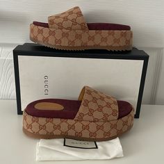 New And Authentic Canvas Jacquard Defines A Slide Sandal Lifted By A Classic Gg-Wrapped Platform. It Comes With A Gucci Box But It Is That The Original Box. It Also Comes With 2 Dust Bags. Description 2 1/2" (64mm) Heel; 1 3/4" Platform Contoured Footbed Textile Upper/Leather Lining/Rubber Sole Comes With Box But It Not Original Luxury Platform Slip-on Sandals, Luxury Slip-on Platform Sandals, Luxury Slides With Platform And Round Toe, Luxury Flat Platform Sandals, Gucci Luxury Sandals With Cushioned Footbed, Luxury Gucci Sandals With Cushioned Footbed, Designer Flat Heel Platform Sandals, Luxury Gucci Slip-on Slides, Luxury Platform Slides