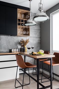 a kitchen table with two chairs next to it and a wine glass holder on the wall