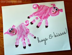 a handprinted card with two pink pigs on it