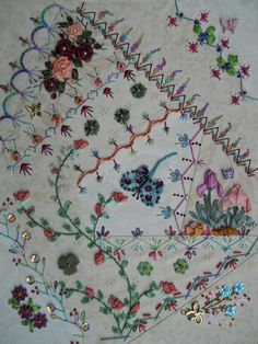 an embroidered table cloth with flowers on it