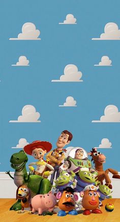 the characters from toy story are standing in front of a blue sky with white clouds