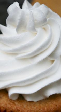 a close up of a cupcake with whipped cream on top