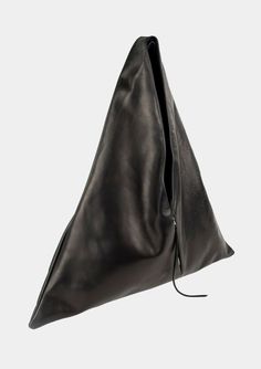 Angular sculpted black leather tote bag with an exterior zip pocket. Lined in a durable cotton canvas with inside leather cell phone pocket. Worn comfortably on the shoulder and hand held.Materials:100% Italian Cowhide Leather100% Cotton Canvas LiningSilver Zippers Dimensions:Handle drop - 14″Width - 24.5″Height - 26.5″Bottom Depth - 3″ Closet Manifestation, Black Canvas Bag, Triangle Tote, Luxury Gloves, Positive Aura, Slouch Bag, Leather Work Bag, Triangle Bag, Slouch Bags