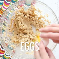 an egg being mixed in a bowl with the word eggs written below it on a colorful background