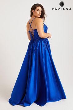 a woman in a long blue dress with an open back and lace detailing on the top