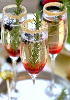 two champagne flutes with christmas decorations in them