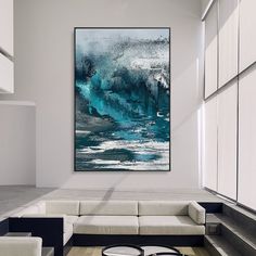 an abstract painting hangs on the wall in a modern living room