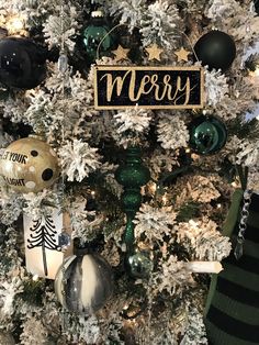 a christmas tree with ornaments on it and a merry sign hanging from the top of it