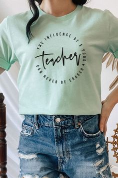 Introducing "The Influence Of A Good Teacher Can Never Be Erased" Heart Graphic Tee from Kissed Apparel. Elevate your merchandise with this impactful and meaningful design. Most t shirt colors are 52/48 cotton/poly blend. White and Cream tees are 100% cotton, Ash tees are 99/1 cotton/poly. Perfect for celebrating the lasting impact of teachers. Order now to enhance your back to school line and captivate customers with this inspiring and heartfelt tee.Made In: USAFabric Contents: Most t-shirt col Inspirational Cotton Tops For Summer, Inspirational Cotton Summer Tops, Inspirational Cotton Tops With Screen Print, Inspirational Cotton Top With Screen Print, Inspirational Cotton Crew Neck T-shirt, Trendy Screen Print T-shirt For Teacher Appreciation, Trendy Screen Print Top For Teacher Appreciation, Inspirational Cotton Tops With Text Print, Inspirational Cotton Tops With Slogan