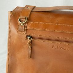 Looking for a sturdy, full-grain leather Messenger Bag? Then this bag is for you! Big enough to meet your office needs and sleek enough to stay stylish - this bag can do it all. Fit your laptop, notebook, pens, books and office essentials in one spot. You're going to love the durability this bag provides, and that you can seamlessly add it to your luggage with the convenient strap on the back. Rectangular Cognac Satchel For On-the-go, Waxed Canvas Laptop Bag With Leather Trim, Satchel Shape, Cognac Leather-lined Briefcase Shoulder Bag, Luxury Leather-handled Crossbody Briefcase, Rugged Leather-backed Briefcase For Business, Luggage Straps, Cheap Bags, Office Essentials, Messenger Bag Men