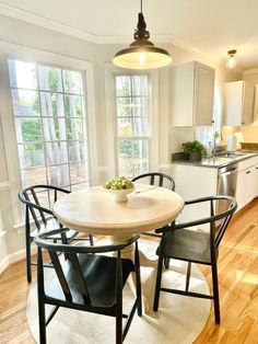 a kitchen table with four chairs around it