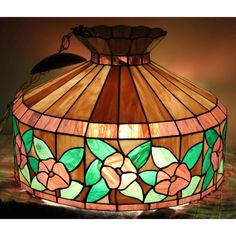 a stained glass lamp with flowers on it