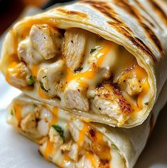 chicken and cheese burrito cut in half on a plate