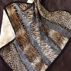 an animal print scarf on top of a wooden table