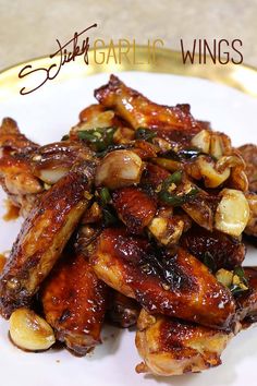 chicken wings with garlic and herbs on a white plate, ready to be eaten or served