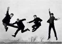 three men jumping in the air with their hands up