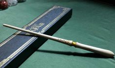 a harry potter's wand on top of a book