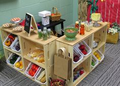 two wooden cartons filled with food on top of a floor next to a wall