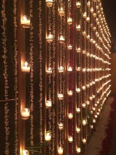 many candles are lit up on the wall