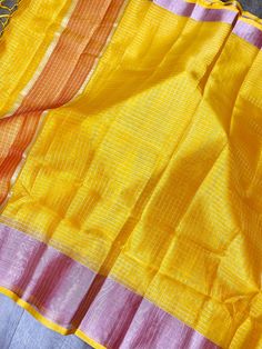 Very Light Weight Tissue Silk Saree in Yellow Mustard Color with Pink borders and Orange Pallu with Zari small Checks all over the Saree. Item : Saree Color : Yellow Base Fabric : Tissue Silk Blouse piece : Comes with un-stitched Blouse piece. Blouse material : Paper Silk Fall & Edging : Comes with Fall and edging (Pico) done Disclaimer: Slight variation in actual color vs. image is possible due to the screen resolution. Multicolor Handloom Dupatta For Summer, Handloom Multicolor Dupatta For Summer, Yellow Saree With Pallu For Summer, Summer Multicolor Handloom Dupatta, Traditional Yellow Saree For Summer, Yellow Dupatta With Weaving Work, Traditional Yellow Summer Saree, Yellow Color Saree, Tissue Silk Saree