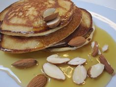 pancakes with almonds and syrup on a plate