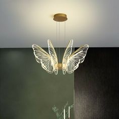 a white butterfly light hanging over a dining room table