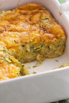 a casserole dish with broccoli and cheese in it on a table