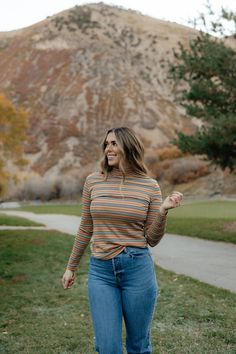 Long story short, we are practically obsessed with our Homebody top! It is the perfect top to wear out, or to simply wear inside next to a cozy fire! We love the mock turtleneck feature and the vibrant toffee color with the hint of white, black, and red stripes. We also love its' lightweight material, but adore how it provides warmth for those colder days ahead! *Meant to be more fitted; stretchy* Material Content: 95% Cotton// 5% Spandex Material Pattern: Stripped Taylor is 5'8" wearing a small Casual Brown Turtleneck For Fall, Casual Turtleneck Tops For Fall, Casual High Neck Tops For Fall, Casual Brown Stretch Turtleneck, Casual Mock Neck Top Turtleneck For Fall, Trendy Turtleneck Top For Fall, Trendy High Neck Tops For Fall, Brown Stretch Turtleneck Tops, Brown High Neck Top For Layering