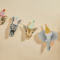 some paper animals are hanging on a clothes line with one animal wearing a party hat