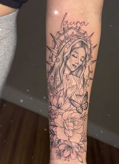 a woman's leg with a tattoo on it and flowers in the foreground