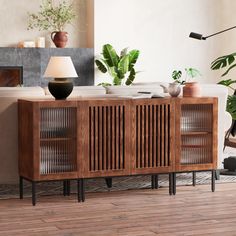 a living room with wooden furniture and potted plants