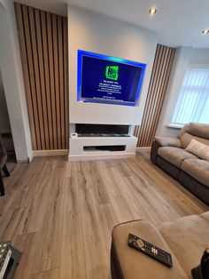 a flat screen tv sitting on top of a wooden floor