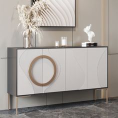 a white and grey sideboard with an abstract design on the front, in a living room