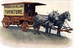 two horses pulling a cart with a sign on the back that says furniture and wheels