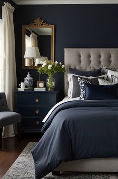 a bedroom with dark blue walls and white bedding